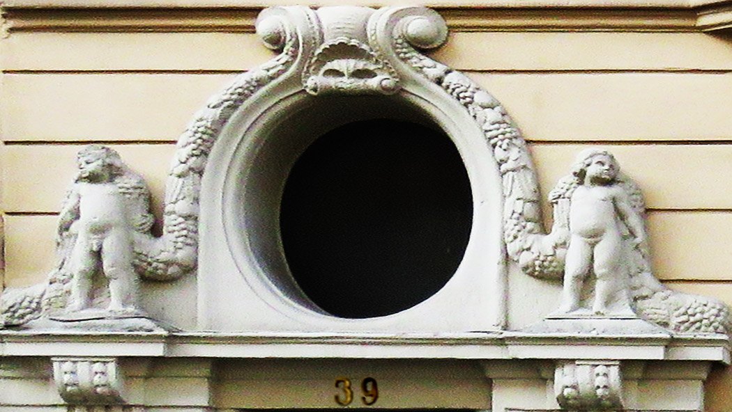Domstraße 39: ovales Fenster mit Putten über dem Hauseingang